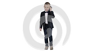 Little boy in a costume making a phone call while walking on white background.