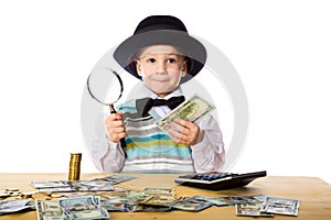 Little boy counting money on the table