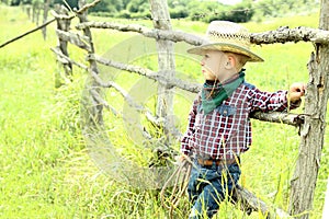 A little boy cowboy on nature