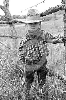 A little boy cowboy on nature