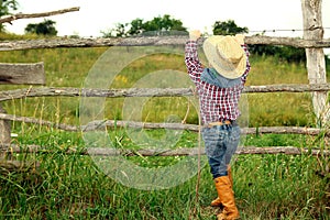 A little boy cowboy on nature