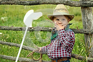 A little boy cowboy on nature