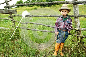 A little boy cowboy on nature