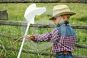 A little boy cowboy on nature