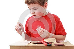 Little boy crafts at small table