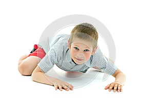 A little boy is crawling on the floor. The concept of children`s