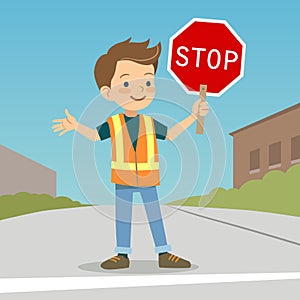 Little boy in crossing guard uniform in the street photo