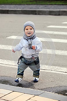 Little boy crossing a street