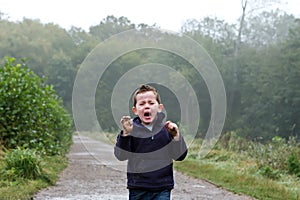 Little boy crying out in the woods