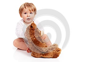 Little boy cuddling with his teddy bear