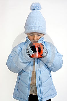 Little boy with cup of hot tea