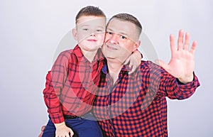 Little boy with dad man. father and son in red checkered shirt. fathers day. happy family. childhood. parenting. Smiling