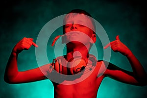 A little boy dances to the music with a spikelet and headphones.