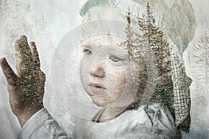 Little boy daydreaming, looking out the window, double exposure