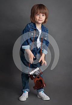 A little boy in denim and vintage camera.