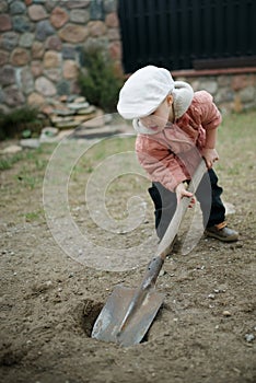 Little boy digging a hole