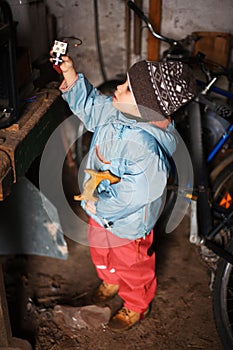 Little boy discovering tools photo