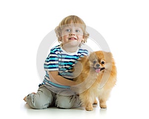 Little boy with dog spitz, isolated on white background