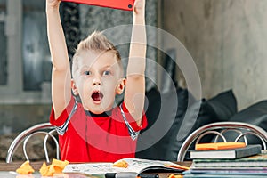 Little boy doing homework in school