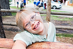Little Boy With Downs-Syndrome Sitting at Table photo