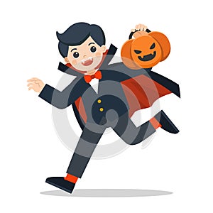 Little boy in Dracula costume with pumpkin basket for Trick or Treat.