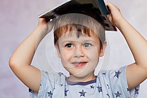 Little boy drawing with color pencils. Little boy is holding color pencils. Boy, drawing a picture for fathers day