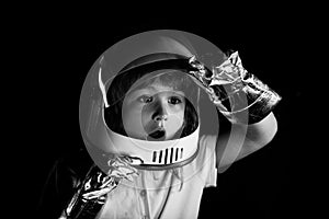 A little boy dreams of becoming an astronaut and flying into space. Cosmos childrens in spacesuit and helmet dreams