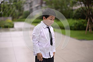 little boy dressed in a white shirt and tie