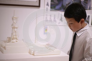 little boy dressed in a white shirt and tie