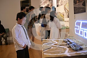 little boy dressed in a white shirt and tie