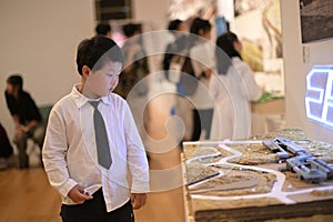 little boy dressed in a white shirt and tie