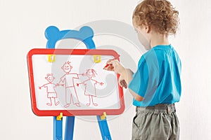Little boy drew a family on a whiteboard