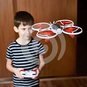 Little boy drives toy quadcopter drone