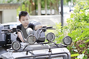 Little boy driving toy car, Vintage Retro Photo Young Boy Play in Pedal Car