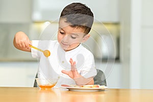 Little Boy Eating Apple With Honey.