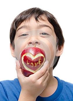 Little boy eating apple , love word on skin focus on apple isolate