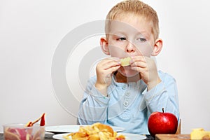 Little boy eating apple for snack