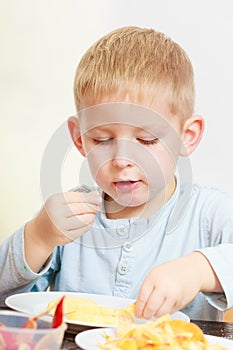 Little boy eating apple for snack