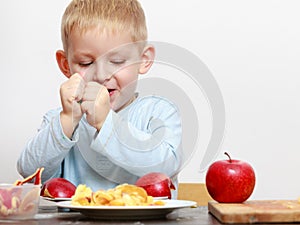 Little boy eating apple for snack