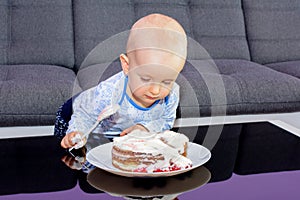 Little boy eating birthday cake with a spoon, happy birthday.