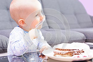 Little boy eating birthday cake with a spoon, happy birthday.