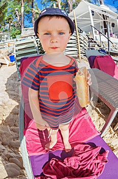 Little boy eating a bread