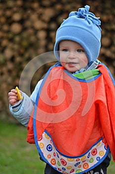 Little boy is eating cookie outside