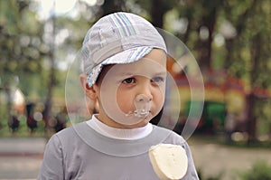 Little boy eating ice cream in the park