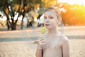 Little boy eating icecream and smile;
