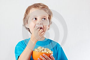 Little boy eating popcorn
