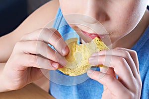 Little boy eating potato chips