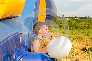 Little boy eating a serving of candy floss