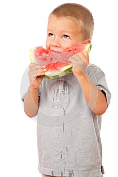 Little boy eating a slice of watermelon