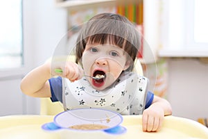 Little boy eating soup